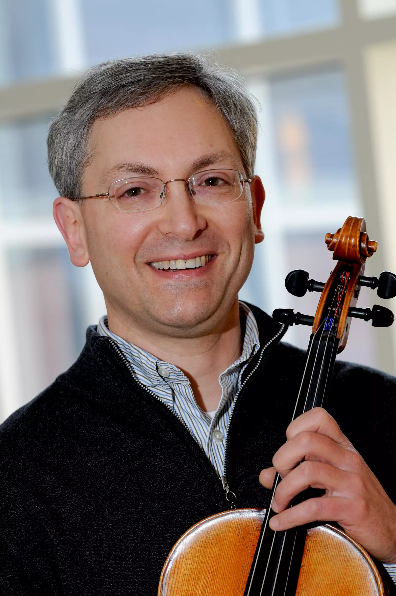 A man holding a violin.