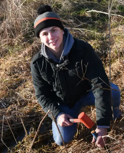 Brett Miller '20 plants a live stake at Susquehanna's Center for Environmental Education and ...
