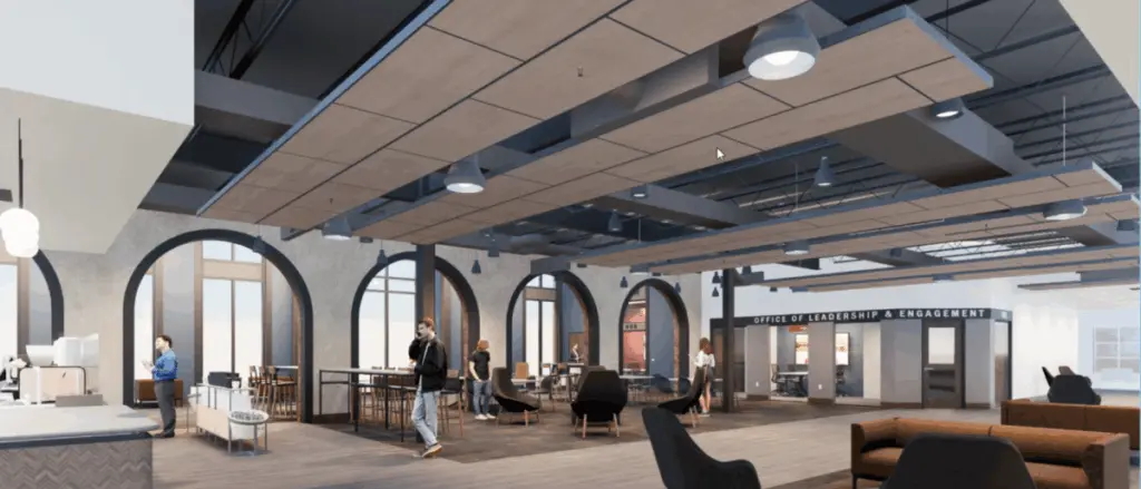 A modern, spacious office lounge—part of our Building and Spaces collection—features high ceilings, large arched windows, inviting seating areas, and people working or conversing near signs for "Office of Leadership & Engagement" and "Career Center.